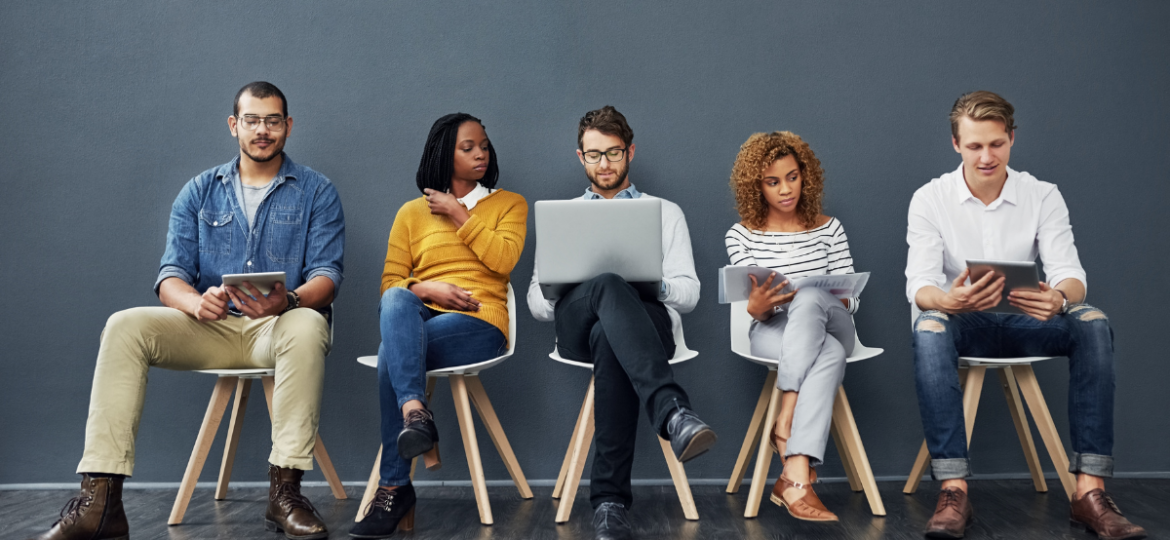 Hiring Bias Blog Graphic showcasing five people sitting in a row of chairs while looking at various items like a tablet, laptop, phone, or book.